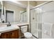 Standard bathroom with white fixtures, including a sink, toilet, and shower stall with sliding doors at 2601 Pemberly Ave, Highlands Ranch, CO 80126