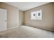 An empty bedroom featuring neutral walls, carpet, and trim, along with a standard window at 2601 Pemberly Ave, Highlands Ranch, CO 80126