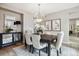 Inviting dining room featuring a chandelier, neutral colors, and sophisticated decor at 2601 Pemberly Ave, Highlands Ranch, CO 80126