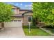 Charming two-story home with stone accents, a well-manicured lawn, and mature trees. A two car garage adds convenience at 2601 Pemberly Ave, Highlands Ranch, CO 80126