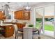 Kitchen area with backyard view, stainless steel hood, granite countertops, wood cabinets at 2601 Pemberly Ave, Highlands Ranch, CO 80126