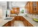 Well-equipped kitchen with wood cabinetry, granite countertops, and a stainless steel range hood at 2601 Pemberly Ave, Highlands Ranch, CO 80126