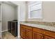 Laundry room with newer front-loading washer/dryer, granite counters, and storage cabinets at 2601 Pemberly Ave, Highlands Ranch, CO 80126
