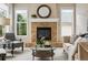 Comfortable living room with a tiled fireplace, plush seating, large windows, and a glass-top table, ideal for relaxation at 2601 Pemberly Ave, Highlands Ranch, CO 80126