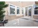 Outdoor patio area with sliding glass doors and a large window offering natural light at 2601 Pemberly Ave, Highlands Ranch, CO 80126