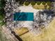 Stunning aerial view of a backyard pool, landscaped yard, and blooming trees at 4027 E Geddes Cir, Centennial, CO 80122
