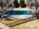 Backyard view of a covered in-ground pool, beautiful foliage and brick fence at 4027 E Geddes Cir, Centennial, CO 80122