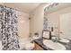 Well-lit bathroom featuring a shower-tub combo, sink with vanity, and decorative accents at 4027 E Geddes Cir, Centennial, CO 80122