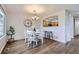 Cozy dining room with white table and chairs, accented by a modern light fixture at 4027 E Geddes Cir, Centennial, CO 80122