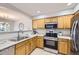 Traditional kitchen with stainless steel appliances and natural wood cabinets at 4027 E Geddes Cir, Centennial, CO 80122
