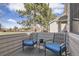 Cozy outdoor patio with comfortable blue cushioned chairs, a side table, and a stylish rug at 4027 E Geddes Cir, Centennial, CO 80122