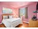 Charming bedroom with a queen-size bed and pink walls at 10068 Darwin Ln, Highlands Ranch, CO 80130