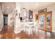 Breakfast nook with white chairs and French doors leading to patio at 10068 Darwin Ln, Highlands Ranch, CO 80130