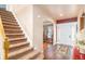 Bright entryway with hardwood floors, staircase, and view to dining room at 10068 Darwin Ln, Highlands Ranch, CO 80130