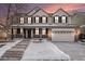 Two-story house with brick facade, attached garage, and snowy front yard at 10068 Darwin Ln, Highlands Ranch, CO 80130