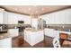 Bright kitchen featuring granite countertops, white cabinets, and stainless steel appliances at 10068 Darwin Ln, Highlands Ranch, CO 80130