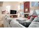 Living room with high ceiling, fireplace, and ample natural light at 10068 Darwin Ln, Highlands Ranch, CO 80130