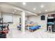 Basement playroom with a large table and arcade game at 10068 Darwin Ln, Highlands Ranch, CO 80130