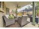 Inviting covered back patio with comfortable seating, ceiling fans, and outdoor dining space at 5426 S Jasper Way, Centennial, CO 80015