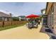 Large backyard features a patio with a red umbrella and a well-maintained lawn at 5426 S Jasper Way, Centennial, CO 80015