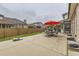Spacious backyard with patio, outdoor seating under a bright red umbrella, and lawn area at 5426 S Jasper Way, Centennial, CO 80015