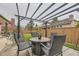 Backyard patio with fire pit and metal shade structure, surrounded by lawn and fencing at 5426 S Jasper Way, Centennial, CO 80015