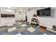 Finished basement featuring updated cabinets, patterned flooring, and fitness equipment at 5426 S Jasper Way, Centennial, CO 80015