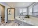 Bright bathroom featuring a tub, separate shower, a window that offers natural light, and wood look floors at 5426 S Jasper Way, Centennial, CO 80015
