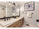 Bathroom showcasing double sinks, granite countertops, and modern fixtures with a framed octopus print at 5426 S Jasper Way, Centennial, CO 80015