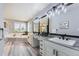 Modern bathroom features double sinks, a large mirror with decorative lighting, and a soaking tub at 5426 S Jasper Way, Centennial, CO 80015
