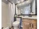 Cozy bathroom featuring a shower with a white curtain, a toilet, and a vanity with a granite countertop at 5426 S Jasper Way, Centennial, CO 80015