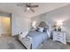 Stylish bedroom featuring gray carpet, full bed, sliding closet door, and matching nightstands with lamps at 5426 S Jasper Way, Centennial, CO 80015
