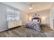 Comfortable bedroom featuring gray carpet, a full bed, a dresser, and matching nightstands with lamps at 5426 S Jasper Way, Centennial, CO 80015