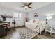Cozy bedroom featuring a trundle bed, a ceiling fan, a desk with computer, and a patterned area rug at 5426 S Jasper Way, Centennial, CO 80015