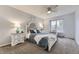 Charming bedroom with gray carpet, a full bed, window bench, and matching nightstands with lamps at 5426 S Jasper Way, Centennial, CO 80015