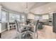 Dining area adjacent to the kitchen featuring a modern light fixture and breakfast bar at 5426 S Jasper Way, Centennial, CO 80015