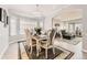 Light and airy dining area with chandelier, wood floors, and natural lighting from bay window at 5426 S Jasper Way, Centennial, CO 80015