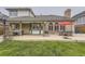 Spacious backyard with patio area including an outdoor kitchen and separate seating under a red umbrella at 5426 S Jasper Way, Centennial, CO 80015