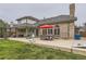 Spacious backyard with patio area including an outdoor kitchen and separate seating under a red umbrella at 5426 S Jasper Way, Centennial, CO 80015