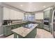 Spacious kitchen boasts granite counters, center island with cooktop, stainless appliances, and modern cabinetry at 5426 S Jasper Way, Centennial, CO 80015