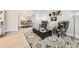 Open concept living room with wood floors, decorative rug, and ample natural light at 5426 S Jasper Way, Centennial, CO 80015