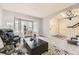 Open layout living area with bay windows, gray walls and direct access to the staircase at 5426 S Jasper Way, Centennial, CO 80015