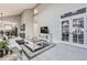 Light-filled living room with vaulted ceilings and French doors to a connected room at 5426 S Jasper Way, Centennial, CO 80015