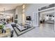 Open living room with brick fireplace, high ceilings, seamless flow to kitchen and office space at 5426 S Jasper Way, Centennial, CO 80015