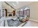 Inviting living room features vaulted ceilings, exposed brick fireplace, and large windows at 5426 S Jasper Way, Centennial, CO 80015