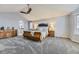 Spacious bedroom boasts vaulted ceiling, ceiling fan, gray carpet, and a bed flanked by nightstands at 5426 S Jasper Way, Centennial, CO 80015