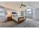 Light-filled bedroom featuring vaulted ceiling, gray carpet, large window, and a bed flanked by nightstands at 5426 S Jasper Way, Centennial, CO 80015