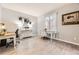 Bright home office with two desks, stylish furnishings, and light-toned wood flooring at 5426 S Jasper Way, Centennial, CO 80015