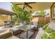 Comfortable outdoor seating area with ceiling fan, green cushions, and backyard pergola at 5426 S Jasper Way, Centennial, CO 80015