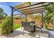 Outdoor pergola with seating, shade covering, and a view of the yard and neighboring houses at 5426 S Jasper Way, Centennial, CO 80015
